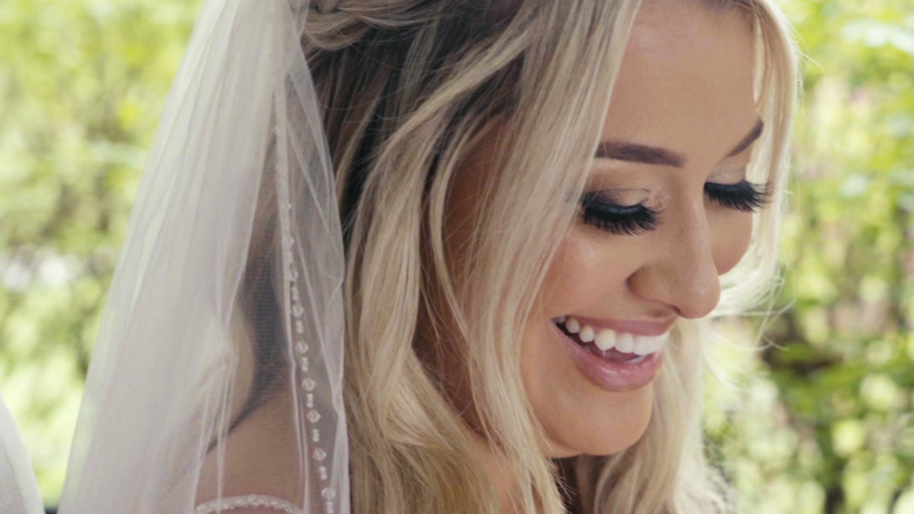A bride smiling as she gets ready for the celebration